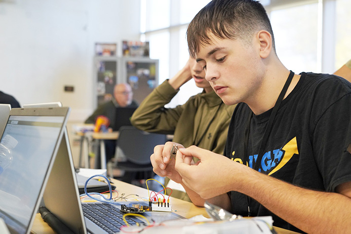 Student wiring a project