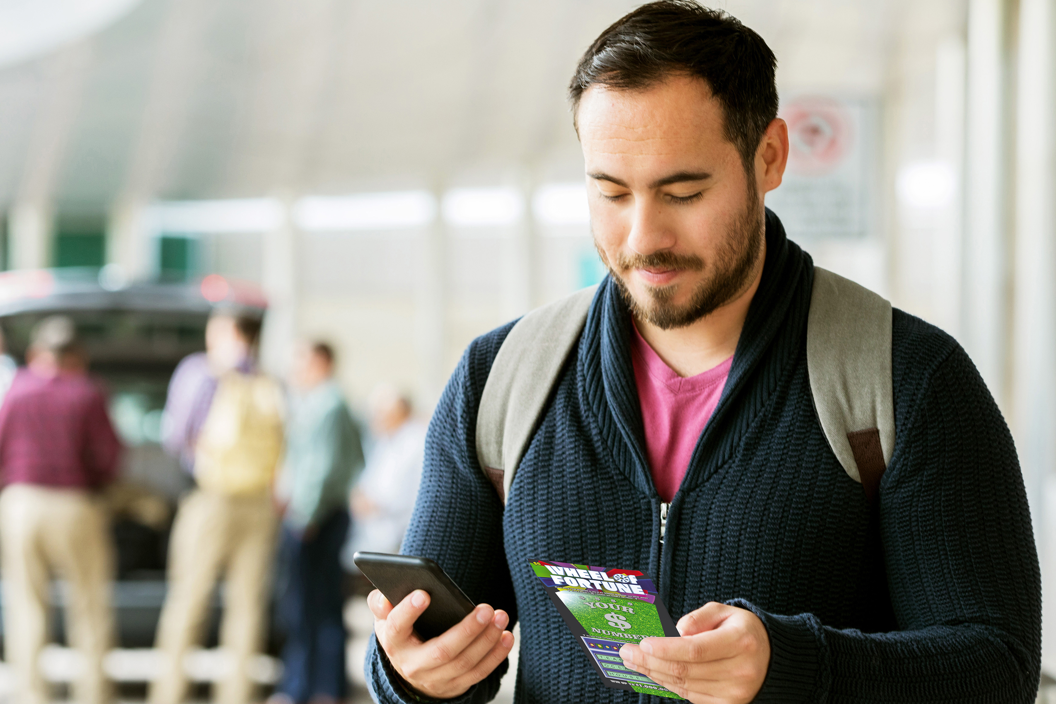 Person looking at the back of a scratch ticket for a second chance opportunity