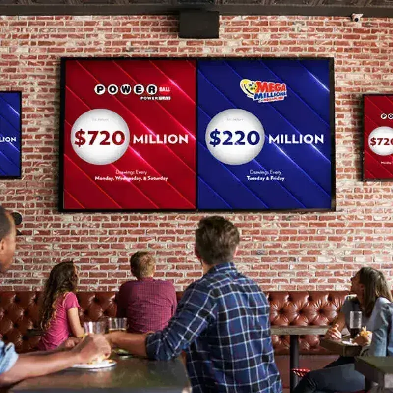 Customers looking at lottery results at a social location