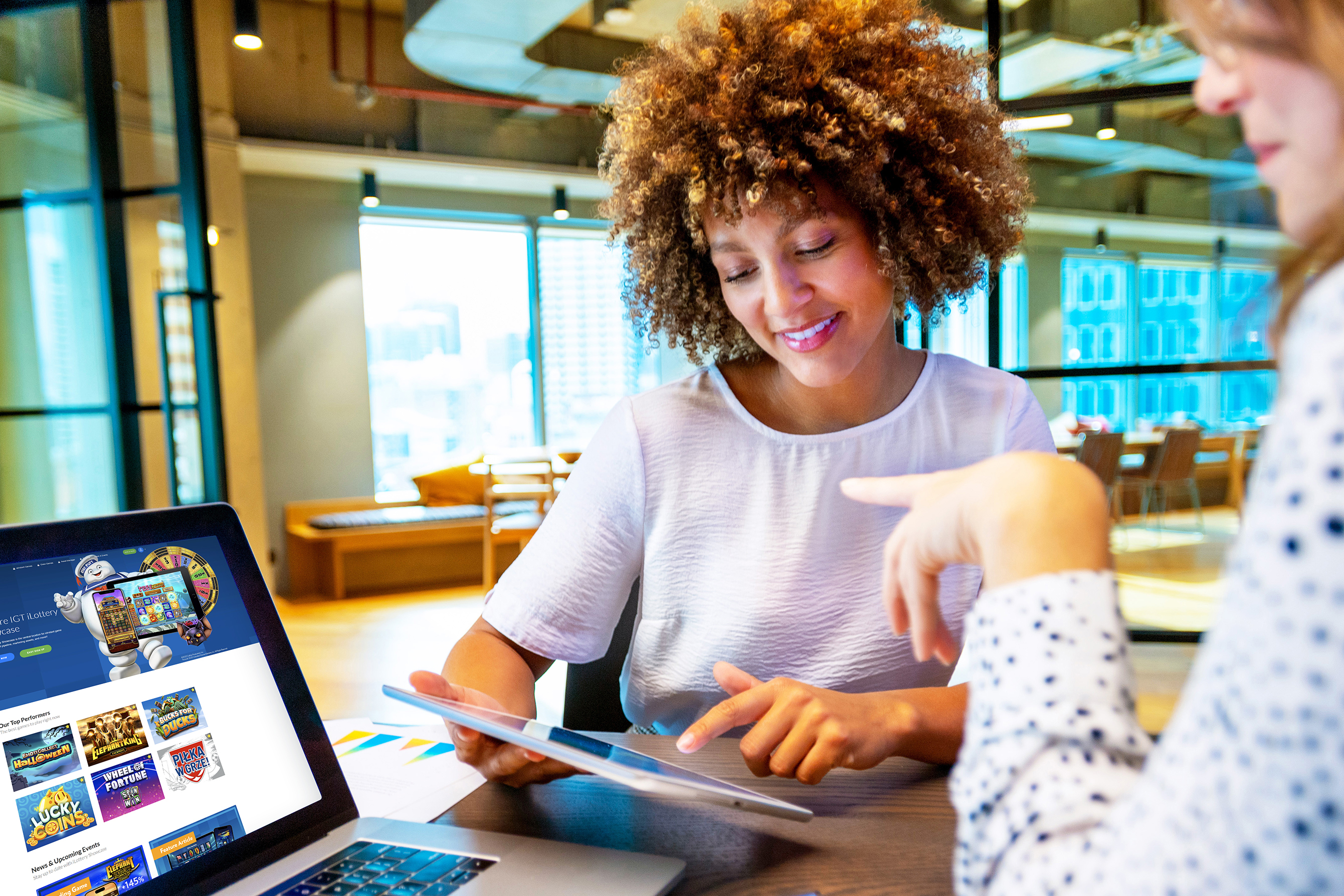 Coworkers meeting by a laptop and using a tablet