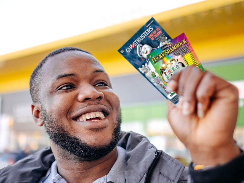 Customer holds high-quality full-color instant tickets